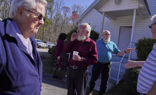 Winfred Kerr, left, Jesse Roberts, and Oscar McGuire stand outside during a break at a Sacred Harp singing event at Holly Springs Primitive Baptist Church in Bremen, Ga., on Saturday, March 22, 2025. (AP Photo/Jessie Wardarski)