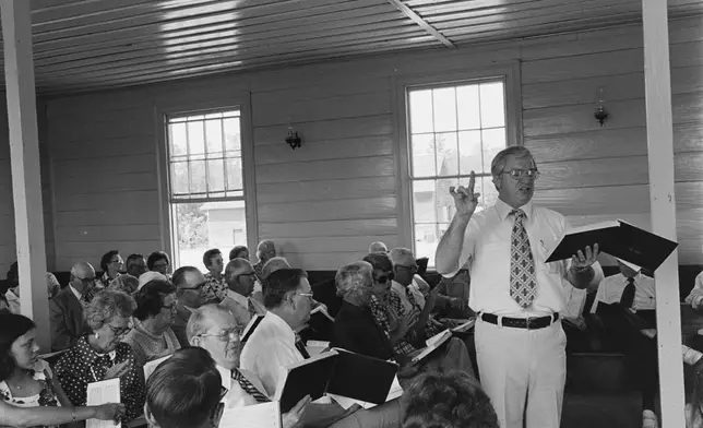 In this photo provided by the Library of Congress, Hugh McGraw leads singers at the South Georgia Sacred Harp Singing Convention in Tifton, Ga., on May 1, 1977. (Howard W. Marshall/Library of Congress via AP)