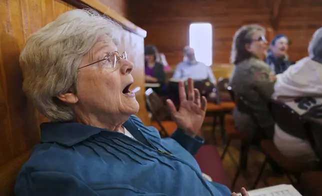 Chris Wilhelm of Black Mountain, N.C., participates in a Sacred Harp singing at Holly Springs Primitive Baptist Church in Bremen, Ga., on Saturday, March 22, 2025. (AP Photo/Jessie Wardarski)