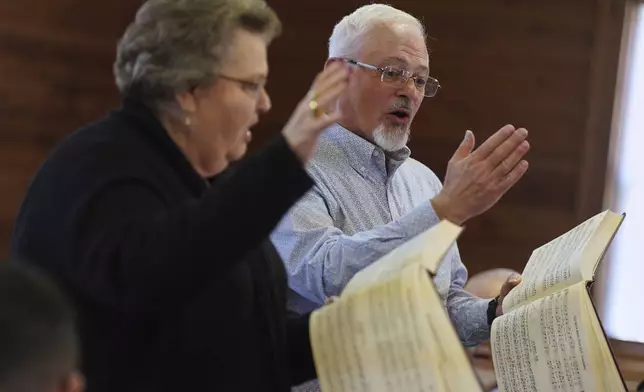 Sacred Harp singers lead from the hollow square, a special formation in which singers, organize into four voice parts and face each other to create an open center, at Holly Springs Primitive Baptist Church in Bremen, Ga., on Saturday, March 22, 2025. (AP Photo/Jessie Wardarski)