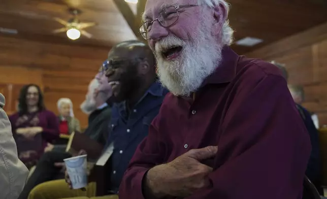 Bridge Hill Kennedy, left, and Jesse Roberts, right, laugh between songs from the bass section at a Sacred Harp singing event at Holly Springs Primitive Baptist Church in Bremen, Ga., on Saturday, March 22, 2025. (AP Photo/Jessie Wardarski)