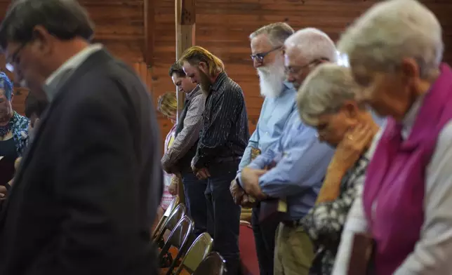 Sacred Harp singers pray at the end of a session at Holly Springs Primitive Baptist Church in Bremen, Ga., on Sunday, March 23, 2025. (AP Photo/Jessie Wardarski)