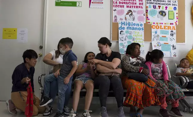 People wait to get vaccinated for measles at a health center in Cuauhtemoc, Chihuahua state, Mexico, Wednesday, April 30, 2025. (AP Photo/Megan Janetsky)