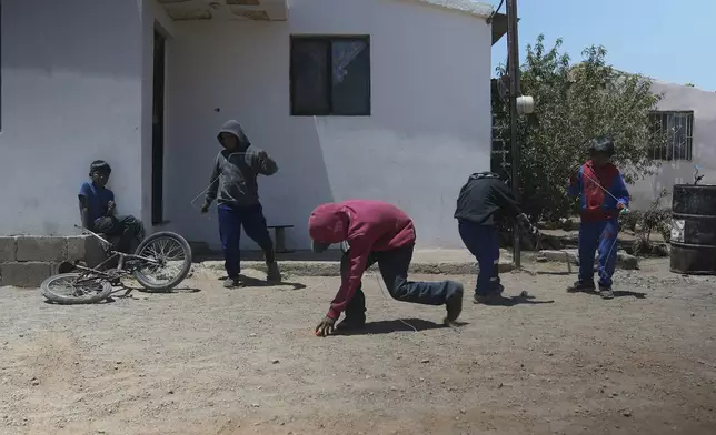 Tarahumara Indigenous children play outside their homes in Cuauhtemoc, Mexico, Thursday, May 1, 2025. (AP Photo/Martin Silva Rey)