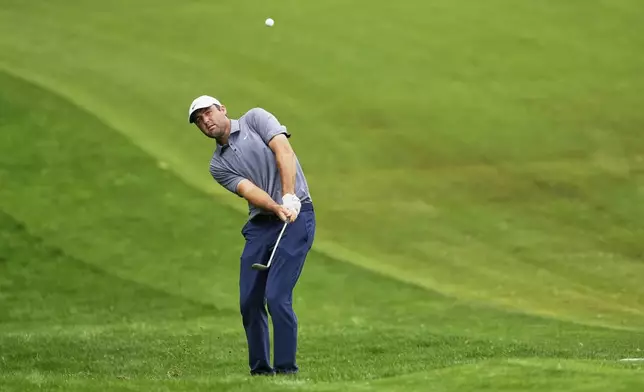 Scottie Scheffler hits from the rough on the eighth hole during the second round of the PGA Championship golf tournament at the Quail Hollow Club, Friday, May 16, 2025, in Charlotte, N.C. (AP Photo/Matt York)