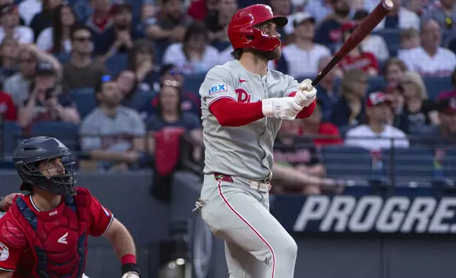 Philadelphia Phillies' Bryce Harper, right, watches his two-run home run off Cleveland Guardians relief pitcher Joey Cantillo as Guardians catcher Austin Hedges, left, looks on during the eighth inning of a baseball game Saturday, May 10, 2025, in Cleveland. (AP Photo/Phil Long)