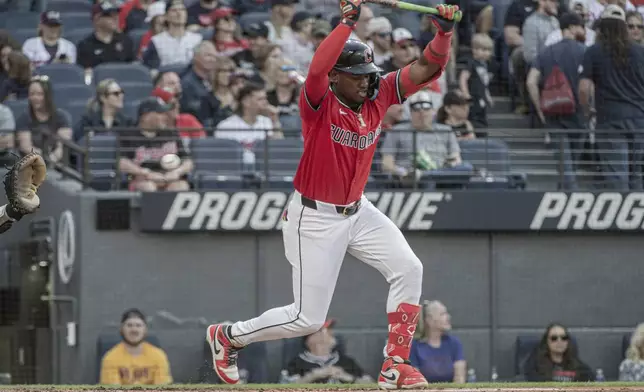 Cleveland Guardians' Angel Martinez dodges an inside pitch from Philadelphia Phillies starting pitcher Ranger Suarez during the third inning of a baseball game Saturday, May 10, 2025, in Cleveland. (AP Photo/Phil Long)