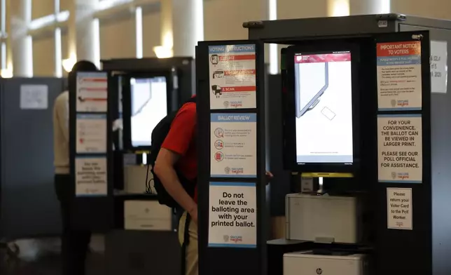 FILE - People vote at voting booths in the Georgia's primary election at Park Tavern June 9, 2020, in Atlanta. (AP Photo/Brynn Anderson, File)
