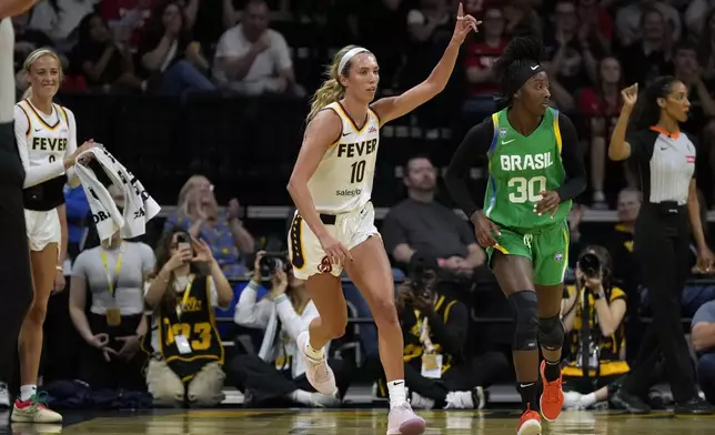 Indiana Fever guard Lexie Hull (10) celebrates after making a 3-point basket during the first half of an exhibition women's basketball game against Brazil, Sunday, May 4, 2025, in Iowa City, Iowa. (AP Photo/Charlie Neibergall)