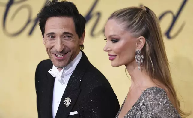 Adrien Brody, left, and Georgina Chapman pose for photographers upon arrival at the amfAR Cinema Against AIDS benefit at the Hotel du Cap-Eden-Roc, during the 78th Cannes international film festival, Cap d'Antibes, southern France, Thursday, May 22, 2025. (Photo by Scott A Garfitt/Invision/AP)
