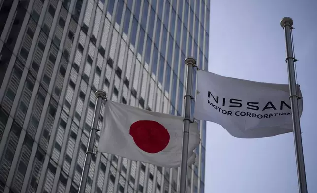 Nissan signage at Nissan headquarters in Yokohama, Tuesday, May 13, 2025. (AP Photo/Louise Delmotte)