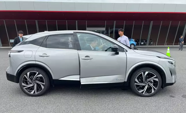 Reporters try out Nissan’s e-Power electrification technology on the current Qashqai model at the company’s Grandrive facility in Yokosuka, Japan, outside Tokyo, Monday, May 26, 2025. (AP Photo/Yuri Kageyama)