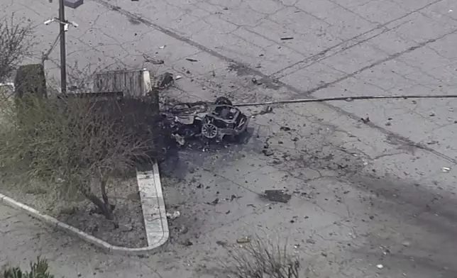 Debris covers the ground and around a vehicle after an explosion on Saturday, May 17, 2025 in Palm Springs, Calif. (ABC7 Los Angeles via AP)
