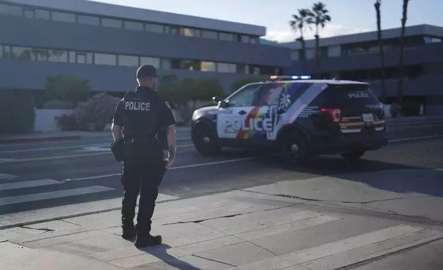 A police officer stands guard at a check point near the site of an explosion in Palm Springs, Calif., on Saturday, May 17, 2025. (AP Photo/Eric Thayer)