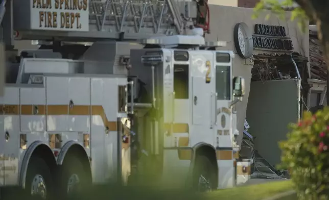 A fire truck is stationed near a building damaged in an explosion in Palm Springs, Calif., on Saturday, May 17, 2025. (AP Photo/Eric Thayer)