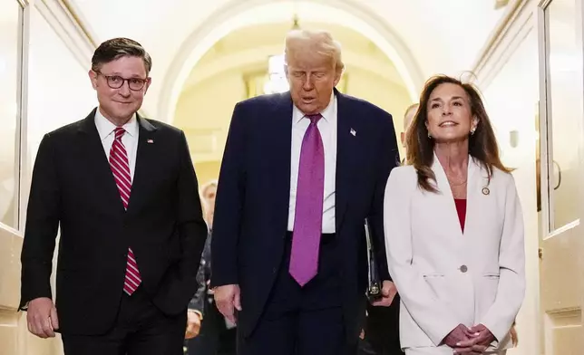 Speaker of the House Mike Johnson, R-La., President Donald Trump and Rep. Lisa McClain, R-Mich., arrive for a House Republican conference meeting, Tuesday, May 20, 2025, at the U.S. Capitol in Washington. (AP Photo/Julia Demaree Nikhinson)