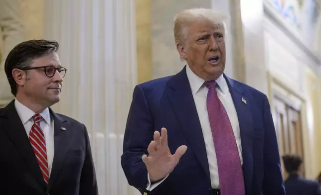 President Donald Trump, right, is joined by Speaker of the House Mike Johnson, R-La., as he arrives for a meeting with the House Republican Conference at the Capitol, Tuesday, May 20, 2025, in Washington. (AP Photo/Rod Lamkey, Jr.)