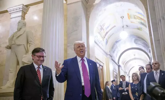 President Donald Trump, right, is joined by Speaker of the House Mike Johnson, R-La., as he arrives for a meeting with the House Republican Conference at the Capitol, Tuesday, May 20, 2025, in Washington. (AP Photo/Rod Lamkey, Jr.)