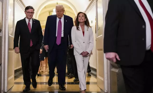 Speaker of the House Mike Johnson, R-La., President Donald Trump and Rep. Lisa McClain, R-Mich., arrive for a House Republican conference meeting, Tuesday, May 20, 2025, at the U.S. Capitol in Washington. (AP Photo/Julia Demaree Nikhinson)