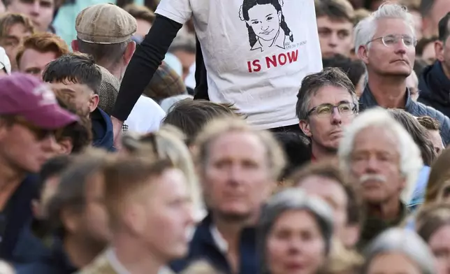 A person protests during a solemn annual national service to commemorate the war dead in Amsterdam, Netherlands, Sunday, May 4, 2025. (AP Photo/Peter Dejong)