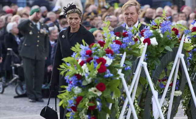 Dutch King Willem-Alexander and Queen Maxima leave after laying a wreath during a solemn annual national service to commemorate the war dead in Amsterdam, Netherlands, Sunday, May 4, 2025. (AP Photo/Peter Dejong)