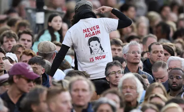 A person protests during a solemn annual national service to commemorate the war dead in Amsterdam, Netherlands, Sunday, May 4, 2025. (AP Photo/Peter Dejong)