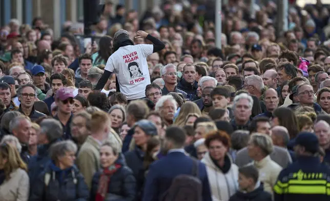 A person protests during a solemn annual national service to commemorate the war dead in Amsterdam, Netherlands, Sunday, May 4, 2025. (AP Photo/Peter Dejong)