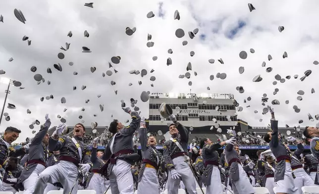 United States Military Academy graduating cadets throw their hats in the air at the end of commencement ceremonies in West Point, N.Y., Saturday, May 24, 2025. (AP Photo/Adam Gray)