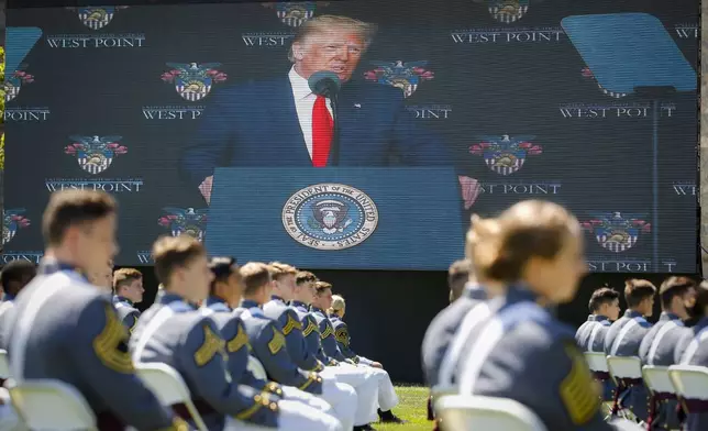 FILE - President Donald Trump is shown on a video screen as he speaks to U.S. Military Academy graduating cadets during commencement ceremonies in West Point, N.Y., June 13, 2020. (AP Photo/John Minchillo, Pool, File)