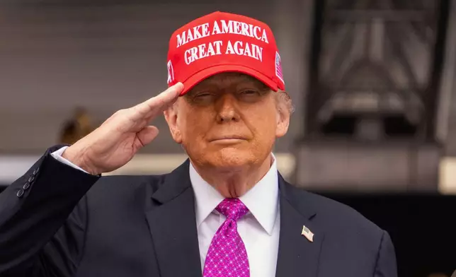 President Donald Trump salutes during the United States Military Academy commencement ceremonies in West Point, N.Y., Saturday, May 24, 2025. (AP Photo/Adam Gray)