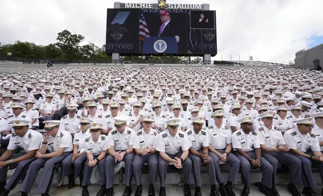 Cadets listen as President Donald Trump, seen on screen, speaks to United States Military Academy graduating cadets during commencement ceremonies in West Point, N.Y., Saturday, May 24, 2025. (AP Photo/Manuel Balce Ceneta)
