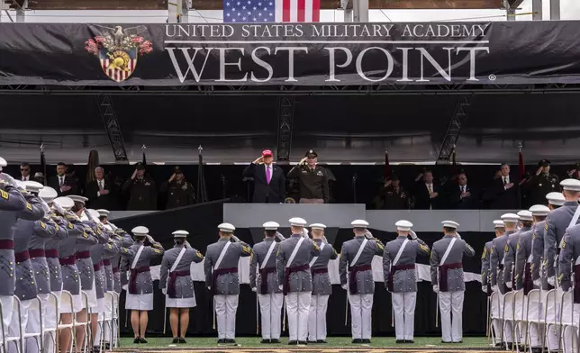 President Donald Trump salutes alongside Lieutenant General Steven W. Gilland during the U.S. Military Academy commencement ceremonies in West Point, N.Y., Saturday, May 24, 2025. (AP Photo/Adam Gray)