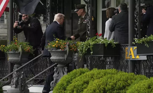 President Donald Trump, second left, is greeted by Steven Gilland, superintendent of the United States Military Academy, as he arrives before delivering the commencement speech at the United States Military Academy commencement ceremonies in West Point, N.Y., Saturday, May 24, 2025. (AP Photo/Manuel Balce Ceneta)