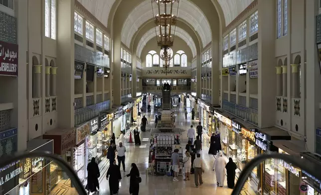 FILE - People shop for gold at a jewelry market in Dubai, United Arab Emirates, Wednesday, April 9, 2025. (AP Photo/Altaf Qadri, File)