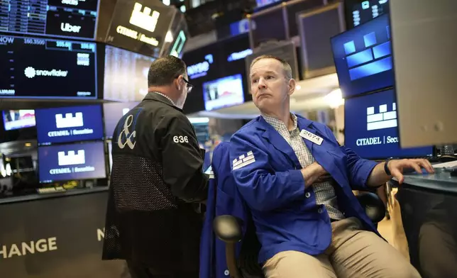 Stephen Naughton works on the floor at the New York Stock Exchange in New York, Wednesday, April 30, 2025. (AP Photo/Seth Wenig)