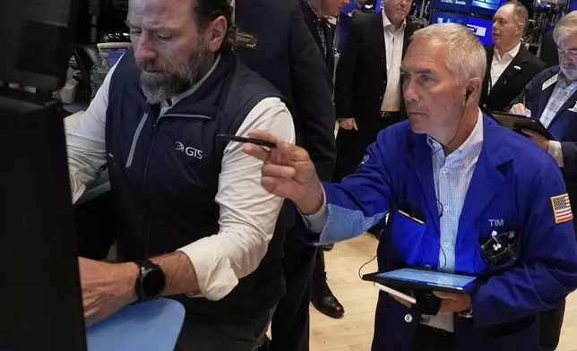 Specialist Michael Pistillo, right, and trader Timothy Nick work on the floor of the New York Stock Exchange, Thursday, May 1, 2025. (AP Photo/Richard Drew)