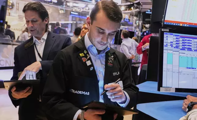 Trader Dylan Halvorsan, right, works on the floor of the New York Stock Exchange, Thursday, May 1, 2025. (AP Photo/Richard Drew)