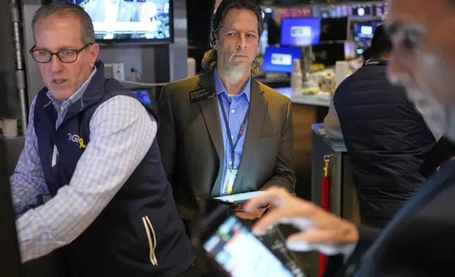 Patrick McKeon, center, works on the floor at the New York Stock Exchange in New York, Wednesday, April 30, 2025. (AP Photo/Seth Wenig)