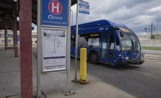 A bus leaves the Pace Harvey Transportation Center, Thursday, May 29, 2025, in Harvey, Ill. (AP Photo/Erin Hooley)