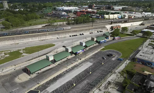 A Metra train, top, is seen in the tracks across from the Pace Harvey Transportation Center, Thursday, May 29, 2025, in Harvey, Ill. (AP Photo/Erin Hooley)