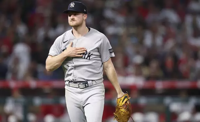 New York Yankees pitcher Clarke Schmidt reacts while walking towards the dugout during the sixth inning of a baseball game against the Los Angeles Angels in Anaheim, Calif., Wednesday, May 28, 2025. (AP Photo/Jessie Alcheh)