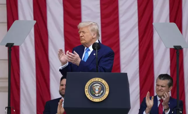 President Donald Trump delivers the Memorial Day Address at the 157th National Memorial Day Observance at Arlington National Cemetery, Monday, May 26, 2025, in Arlington, Va., as Vice President JD Vance and Secretary of Defense Pete Hegseth, right, look on. (AP Photo/Julia Demaree Nikhinson)