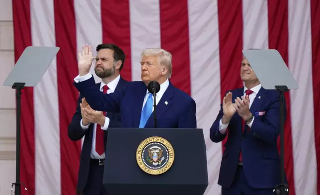 President Donald Trump delivers the Memorial Day Address at the 157th National Memorial Day Observance at Arlington National Cemetery, Monday, May 26, 2025, in Arlington, Va., as Vice President JD Vance and Secretary of Defense Pete Hegseth, right, look on. (AP Photo/Julia Demaree Nikhinson)