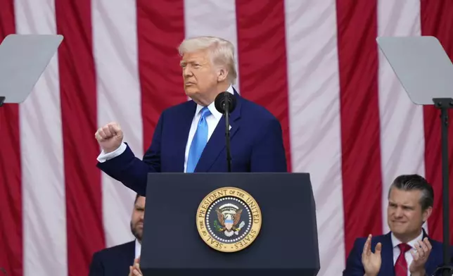 President Donald Trump delivers the Memorial Day Address at the 157th National Memorial Day Observance at Arlington National Cemetery, Monday, May 26, 2025, in Arlington, Va., as Vice President JD Vance and Secretary of Defense Pete Hegseth, right, look on. (AP Photo/Julia Demaree Nikhinson)
