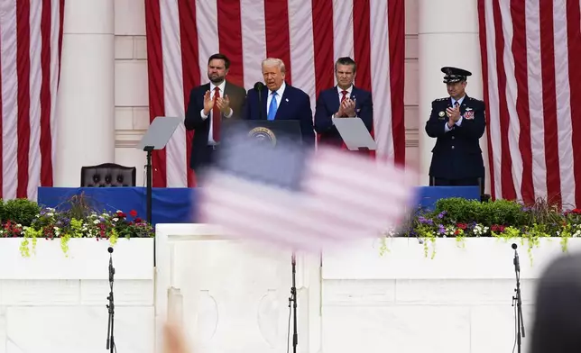 President Donald Trump delivers the Memorial Day Address at the 157th National Memorial Day Observance at Arlington National Cemetery, Monday, May 26, 2025, in Arlington, Va., as Vice President JD Vance, Secretary of Defense Pete Hegseth and U.S. Air Force Gen. Dan Caine, right, look on. (AP Photo/Julia Demaree Nikhinson)