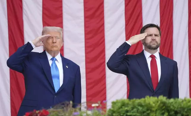 President Donald Trump and Vice President JD Vance salute during the 157th National Memorial Day Observance at Arlington National Cemetery, Monday, May 26, 2025, in Arlington, Va. (AP Photo/Jacquelyn Martin)