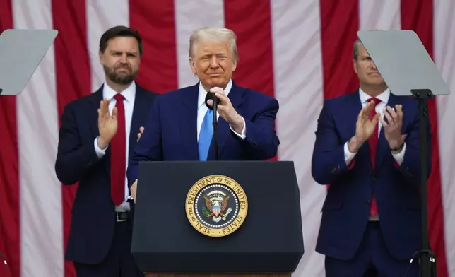President Donald Trump delivers the Memorial Day Address at the 157th National Memorial Day Observance at Arlington National Cemetery, Monday, May 26, 2025, in Arlington, Va., as Vice President JD Vance and Secretary of Defense Pete Hegseth, right, look on. (AP Photo/Julia Demaree Nikhinson)