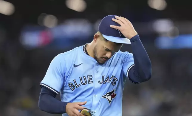 Toronto Blue Jays pitcher Jose Berrios returns to the dugout after first-inning baseball game action against the Boston Red Sox in Toronto, Thursday, May 1, 2025. (Chris Young/The Canadian Press via AP)