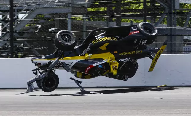 The car driven by Colton Herta goes airborne after hitting the wall in the first turn during a qualification attempt for the Indianapolis 500 auto race at Indianapolis Motor Speedway in Indianapolis, Saturday, May 17, 2025. (AP Photo/Kirk DeBrunner)