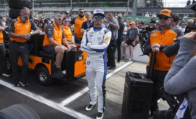 Kyle Larson watches with his crew as he waits for is turn during qualification for the Indianapolis 500 auto race at Indianapolis Motor Speedway in Indianapolis, Saturday, May 17, 2025. (AP Photo/Michael Conroy)